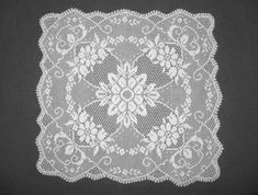 a white lace doily on a black background