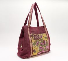 Beautifully crafted, this day tote boasts a fully beaded and embroidered panel that hides a zipper pocket, ideal for all those items you need to be able to grab quickly. An embellished shoulder strap gives you the hands-free option you need for busy days, while internal pockets keep things organized. From America & Beyond. Embroidered Double Handle Bag For Everyday Use, Embroidered Double Handle Shoulder Bag, Embroidered Double Handle Satchel For Everyday Use, Fashion Handbags, Hands Free, Tote Handbags, Zipper Pocket, Zip Pockets, Shoulder Strap