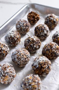 a tray filled with lots of chocolate covered donuts