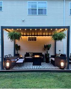 an outdoor living area with patio furniture and lights