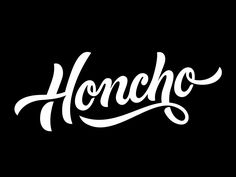 the word honcho written in cursive script on a black background with white ink