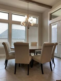 a dining room table with chairs and a chandelier