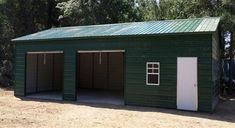 a green building with two doors and one side door is shown in front of some trees