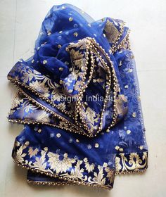 Blue Net Dupatta for women. Dupatta is custom made for bridal weddings It is made using dyeable net fabric with golden Sequines work all over. A Banarsi Brocade border along with Golden beaded lace is attached to dupatta. Dupatta is having a length of 100 inches and width of around 40 inches. I don't keep it readymade I only make it exclusively for my customers. Can be fully customised. Blue Organza Choli With Cutdana, Blue Anarkali Set With Sheer Dupatta For Festivals, Royal Blue Cutdana Dupatta, Blue Chanderi Anarkali Set With Embroidered Border, Blue Chanderi Traditional Wear With Sheer Dupatta, Blue Organza Sets With Dori Work, Royal Blue Sharara With Dupatta For Festive Occasions, Festive Royal Blue Sharara With Dupatta, Unstitched Blue Anarkali Set With Embroidered Border