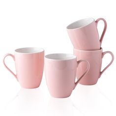 three pink coffee cups sitting next to each other