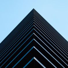 the top of a tall black building against a blue sky