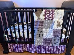 a baby crib that has some blankets on it