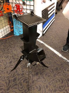 a black tripod sitting on top of a carpeted floor