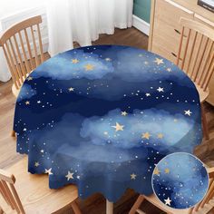 the table cloth has stars on it and is blue with white clouds in the sky