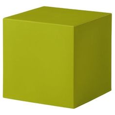 a green cube sitting on top of a white floor