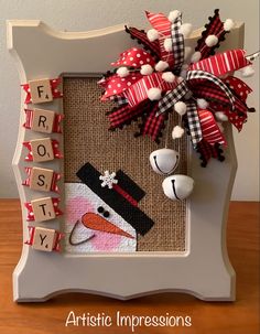 a snowman made out of scrabbles and fabric with the words frosty written on it