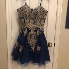 Navy Strapless Dress With Gold Embroidery. Lace Up/Corset Back. New With Tags. Such A Beautiful Dress Pictures Don’t Do It Justice. New With Tags. Built In Padding In Chest. Fitted Embroidered Dresses For Prom Season, Blue Prom Dress With Floral Embroidery, Fitted Dress With Intricate Embroidery For Prom, Blue Floral Embroidered Prom Dress, Royal Blue Mini Dress For Homecoming, Homecoming Dresses With Sweetheart Neckline And Floral Embroidery, Elegant Blue Embroidered Party Dress, Elegant Embroidered Dress For Homecoming, Floral Embroidered Dresses For Homecoming And Prom