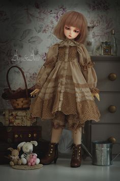 a doll with blonde hair standing next to a dresser