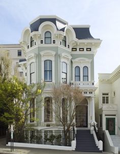 a large white house with many windows and balconies