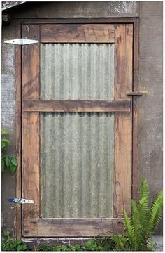 an old wooden window with metal slats on it