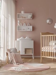 a baby's room with pink walls and white furniture