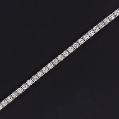 This brilliantly sparkling tennis bracelet has a classic design that will never go out of style! Featuring 2 carats of bright white, eye clean diamonds, this beauty offers brilliant, eye catching sparkle. This bracelet is sure to delight and would make an excellent gift for a special someone or for yourself.Brilliantly white, the diamonds are graded G-H for color. For clarity, the diamonds are graded SI1-SI2, and they are eye clean. The diamonds are all exceptionally well cut and display fantast White Diamond Tennis Bracelet With Diamond Accents, Luxury White Brilliant Cut Tennis Bracelet, Luxury Brilliant Cut White Tennis Bracelet, Dazzling Diamond White Tennis Bracelet With Diamond Accents, White Brilliant Cut Tennis Bracelet, Luxury White Diamond Tennis Bracelet, Luxury White Tennis Bracelet With Prong Setting, Timeless White Diamond Tennis Bracelet, Luxury White Cubic Zirconia Tennis Bracelet