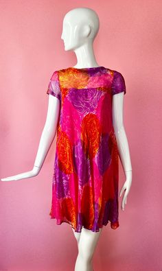 "Amazing and rare 1960s dress! Hot pink, orange, purple swirl pattern Trapeze swing shape Mini length Pink lining that zips up Chiffon over layer that buttons up back with bow hook at top Short sleeve Tag: Gino Charles (collaboration line by Malcolm Starr and Teal Traina) Condition: excellent, no flaws noted Measurements: (Measured from lining since it is more fitted) 34\" bust 31\" waist 38\" hips 14\" shoulder 34\" long" Retro Pink Silk Dress, Pink Silk Retro Dress, Pink Retro Silk Dress, Purple Swirl, 1960's Dress, Vintage Style Dresses, Swirl Pattern, Floral Mini Dress, Dress Clothes For Women