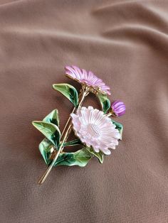 Pink and green enameled floral brooch.  Gold plated. Green Spring Brooches Perfect As A Gift, Green Spring Brooches As Gifts, Spring Green Brooch Gift, Green Spring Gift Brooches, Elegant Green Enamel Pin, Flower Shaped Enamel Pin For Gift, Enamel Flower Brooch Pin, Elegant Flower Enamel Pin Collectible, Floral Enamel Brooch Pin