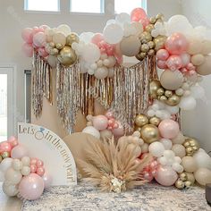 a table topped with balloons and tassels