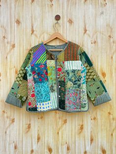 a colorful jacket hanging on a wooden wall