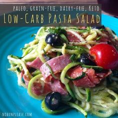 a blue plate topped with pasta and veggies