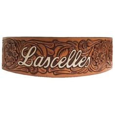 a brown leather belt with the word larcelle on it's side and an ornate