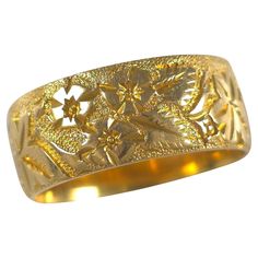 Edwardian 18ct yellow gold Keeper ring, engraved with a foliate decoration. • Assay: .750 Gold (18ct), Chester Assay marks. • Period: Early 20th Century. • Date: Circa 1905 (Date stamp is rubbed). • Maker: Marked 'JE'. • Measurement: UK ring size M 1/2 (leading edge), US ring size 6 1/2 (leading edge); 7.2mm band width. • Weight: 5.1 grams. Condition: Good antique condition with light surface scratches and wear typical for its age. Refer to photographs for a detailed view. Item No: 2344_gth1. Ceremonial Yellow Gold Engraved Ring With Decorative Band, Gold Engraved Ring With Wide Band Stamped 14k, Traditional 14k Yellow Gold Engraved Ring, Heirloom Gold Filigree Ring With Decorative Band, Gold Engraved Ring With Intricate Design For Promise, Victorian Gold Engraved Ring With Decorative Band, Ornate Gold Engraved Ring Hallmarked, Antique Etched Yellow Gold Rings, Ornate Gold Engraved Hallmarked Ring