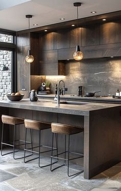 a large kitchen with an island and bar stools next to the counter top that has three lights on it