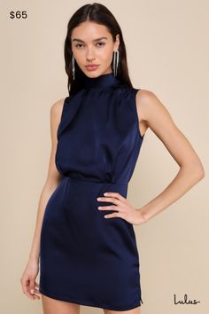 Feel like pure royalty for an evening in the Lulus Classic Elegance Navy Satin Sleeveless Mock Neck Mini Dress! Luxe stretch-woven satin shapes this gorgeous dress that has a mock neckline and a sleeveless bodice with gathered fabric detailing. An elasticized waist tops a flirty mini skirt complete with a side notch. Keyhole opening and double button closure at back. Hidden back zipper/clasp. Fit: This garment fits true to size. Length: Mid-thigh. Size medium measures 33.5" from shoulder to hem. Fitted High Neck Sleeveless Dress For Date Night, Sleeveless Dresses With Fitted Waist For Date Night, Sleeveless Dress With Fitted Waist For Night Out, Flattering Sleeveless Dress For Date Night, Fabric Detailing, Gathered Fabric, Sleeveless Mock Neck, Mock Neck Mini Dress, Black Tie Gala