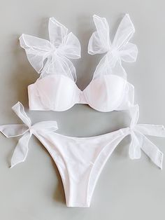 a white bikinisuit with two bows on the front and one bow at the back