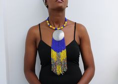 African beaded fringe necklace, Beaded Multi-strand necklace, Beaded Women necklace, Statement Necklace, Christmas gift for her, Moms gift An elegant necklace that can match any outfit. Handmade by the Maasai women in Kenya using fine beads. Color: blue and yellow Dimensions:  Necklace length: 18 inches/ 46 cm Neck size: 15 inches / 38 cm 3-5 days delivery via DHL Express.  Pay shipping fee for the first item only and additional items ship for free. To view more items in our shop, kindly click here:  nkoroicrafts.etsy.com Adjustable Beaded Necklaces With Fringe And Round Beads, Beaded Fringe Necklaces With Round Beads As Gifts, Beaded Fringe Necklace With Round Beads As Gift, Adjustable Beaded Necklaces With Beaded Fringe As Gift, Gift Necklace With Beaded Fringe And Round Beads, Fringe Necklace, Women Necklace, Elegant Necklace, Christmas Gift For Her