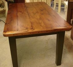 a wooden table sitting on top of a carpeted floor