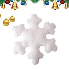 a snowflake with bells and christmas ornaments hanging from it's sides on a white background