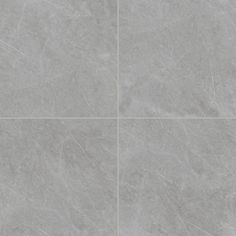 a grey tile floor with four squares in the middle