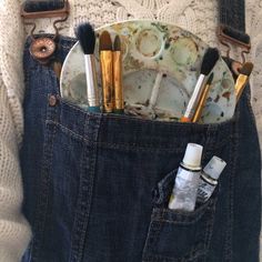 a pocket full of makeup brushes and other items in it's back pocket,