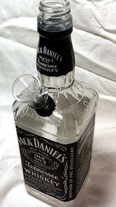 a bottle of jack daniels whiskey sitting on top of a white sheet