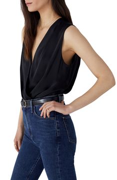 Date night is calling in this blousy sleeveless top styled in a sultry wrapped fit. Surplice V-neck Sleeveless Lined gusset 100% polyester Dry clean or hand wash, dry flat Imported Chic V-neck Bodysuit For Date Night, Chic Sleeveless Bodysuit For Date Night, Elegant Sleeveless Bodysuit For Evening, Sleek Sleeveless Bodysuit For Night Out, Sleek Sleeveless Bodysuit For Workwear, Elegant Sleeveless Evening Bodysuit, Sleeveless Sleek Top For Date Night, Sleek Sleeveless Top For Date Night, Sleeveless Bodysuit For Date Night