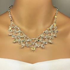 This Large Swarovski Crystal Statement Necklace Set is about as sparkly as you can get. Perfect for an evening wedding or a New Year's Eve party. You will receive the necklace and earrings. This beauty is hand beaded, taking about 6 hours to create.  It is designed with genuine Swarovski Crystals in 4 and 6mm, sterling silver ball beads with a sterling silver lobster clasp. It is 18 inches in length and approx 2 inches going up to 1 1/2 inches in width.  This exact necklace set is available to ship now and is the last one. Crystal Bridal Necklace With Jewels For Celebration, Silver Crystal Embellished Jewelry For Celebrations, Crystal Jeweled Bridal Necklace For Celebration, Beaded Bridal Jewelry, Prom Jewelry Sets, Formal Jewelry, Bridal Necklace Set, Crystal Statement Necklace, Bling Necklace