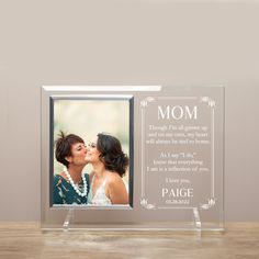 an acrylic photo frame with the words, mom and two women kissing each other