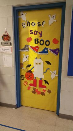 a door decorated with halloween decorations and ghost saying,'ghost say boo'on it