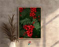 a vase with some red berries on it next to a wall mounted art piece in a room