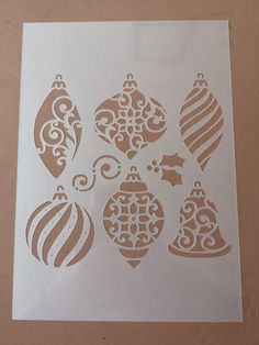 a sheet of paper with ornaments cut out on it