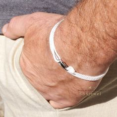 "Men's rope bracelet CLASSIC WHITE ❂ The bracelet made of ❂ 0.08\" (about 2.5mm) width polyester woven black rope, with one sliding knot, and high quality stainless steel lobster claw clasp 0.63\" (16mm) The bracelet is very light weight. It's not a survival bracelet. All unique and different colors rope bracelets see here: https://www.etsy.com/shop/SBSjewel?section_id=23916313 ❂ SIZES ❂ Despite the fact that the size of the bracelet could be universal, I will offer you, dear customers, 3 size r White Nylon Cord Bracelets For Beach, White Braided Bracelet With Adjustable Waxed Cord, Adjustable White Hand-strung Braided Bracelets, Hand-strung Waxed Cord Bracelets For Beach, Hand-strung Waxed Cord Beach Bracelets, Rope Bracelet Men, White Rope, Surfer Bracelets, Survival Bracelet