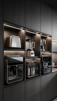 a kitchen with black cabinets and stainless steel appliances on the countertop, along with other appliances