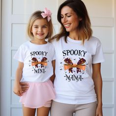 Spooky Mama Spooky Mini T-Shirt, Kids Halloween Shirt, Matching Family Shirt, Funny Spooky Mama Shirt, Family Halloween Shirt, Gift For Mom **Discover Comfort and Durability For our printing, we've handpicked top-quality shirts from Bella Canvas and Gildan SoftStyle brands, renowned for their excellence in the industry. *Bella Canvas* - Available in unisex sizes - Weighing 4.2 oz. - Solid colors feature a luxurious blend of 100% Combed Cotton and Ring-Spun Cotton. - Athletic Heather boasts 90% Combed and Ring-Spun Cotton, and 10% Polyester. - All Heather CVC Colors are crafted with 52% Combed and Ring-Spun Cotton, and 48% Polyester. *Gildan SoftStyle* - Also available in unisex sizes - Sport Gray: 4.5 oz/yd² | 90% Ring Cotton / 10% Polyester - Heather Navy, Heather Maroon, Heather Galapago In My Spooky Mama Era, Halloween Family Matching Crew Neck T-shirt, Spooky Mama Shirt, Spooky Custom Print T-shirt For Fall, Matching Family Shirt, Halloween Shirts Kids, Spooky Mama, Family Shirts Matching, Family Shirt