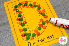 the letter d is for dot with gummy bears on it and a marker next to it