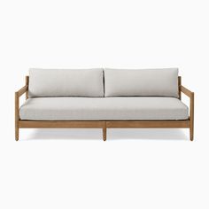 a white couch sitting on top of a wooden frame