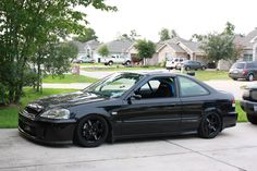 a black car parked in front of a house