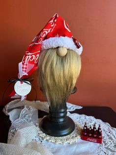 a wig wearing a coca cola hat on top of a table